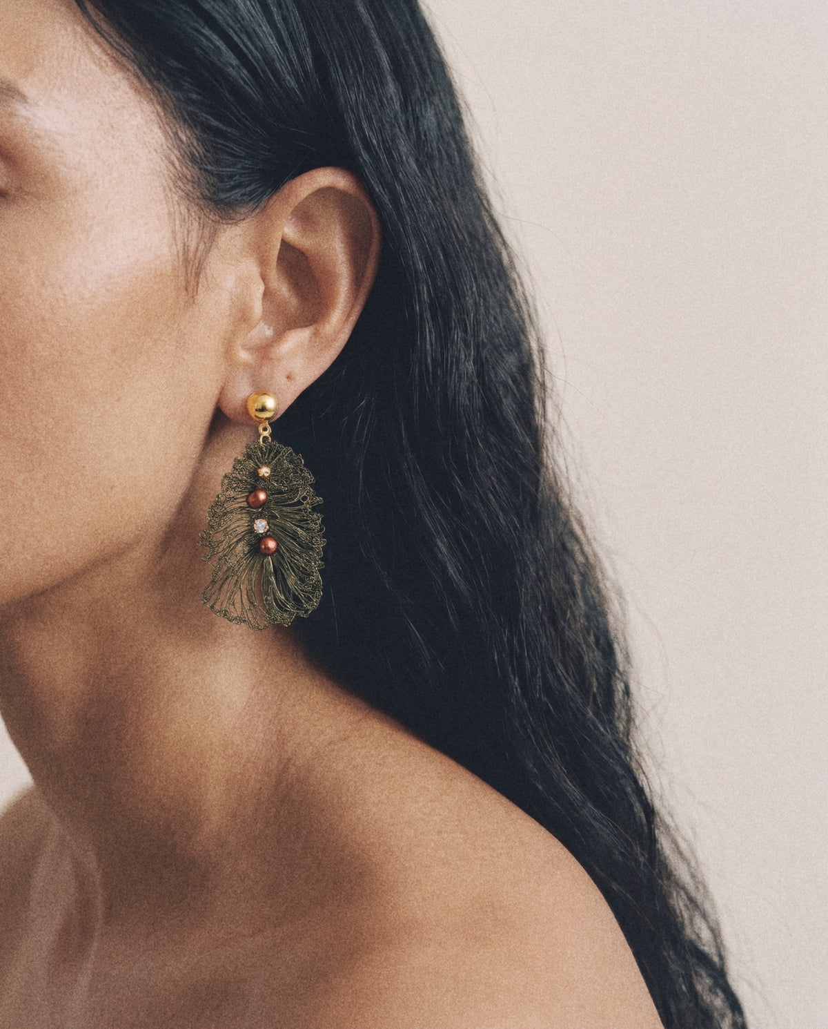 Seeded Leaf Earrings in olive, worn