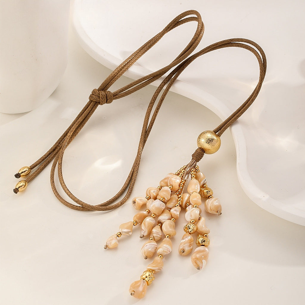 Shell Tassel Necklace — Peach Cream, laid flat