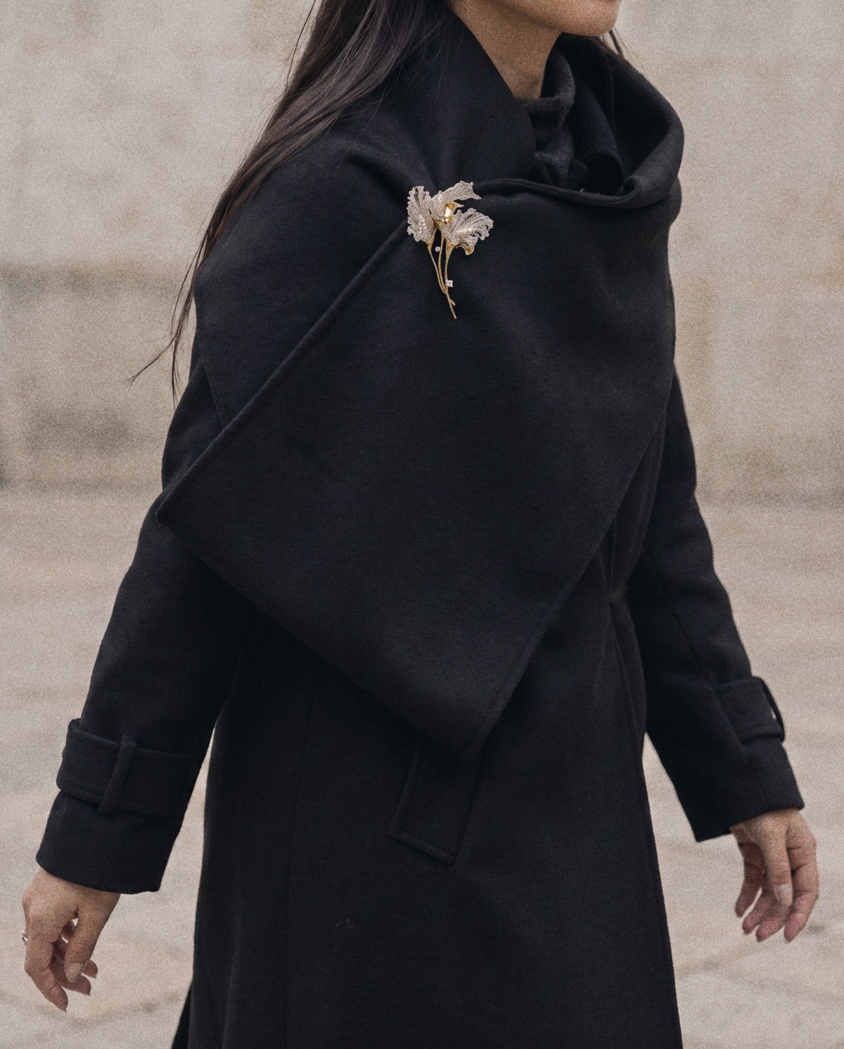 Silver Calla Brooch worn on a black wool coat