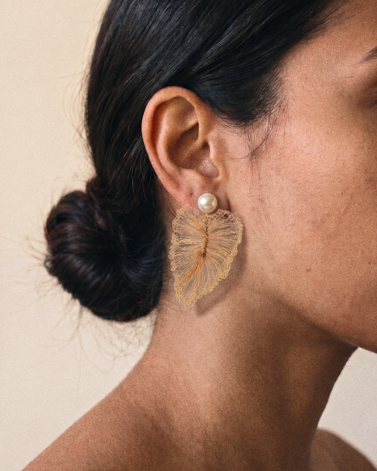 Pearl Leaf Earrings in peach gold, worn