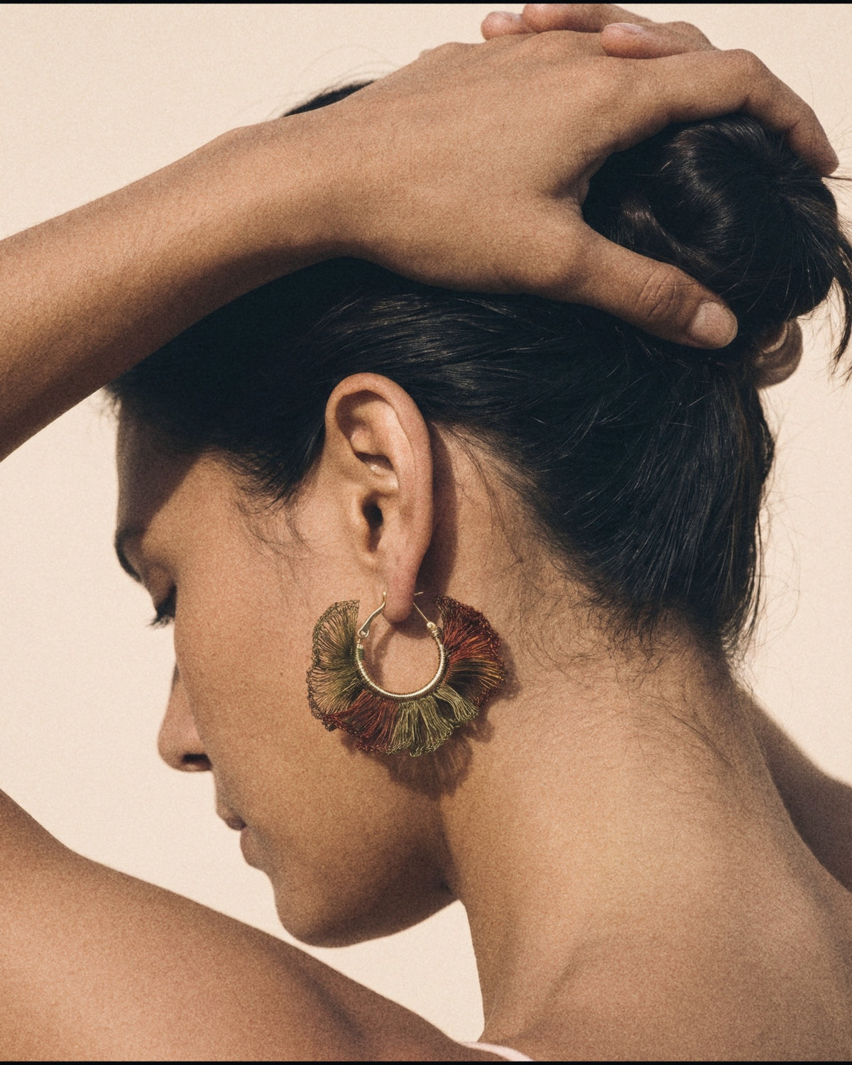 Ruffle Hoop Earrings in olive rust, worn